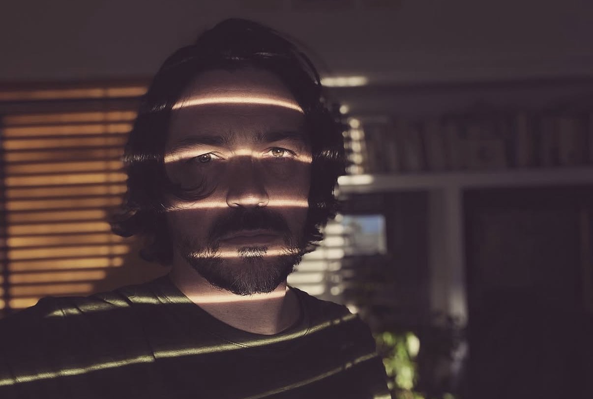 CHRISTIAN LETRURIA in a portrait crossed by bands of light